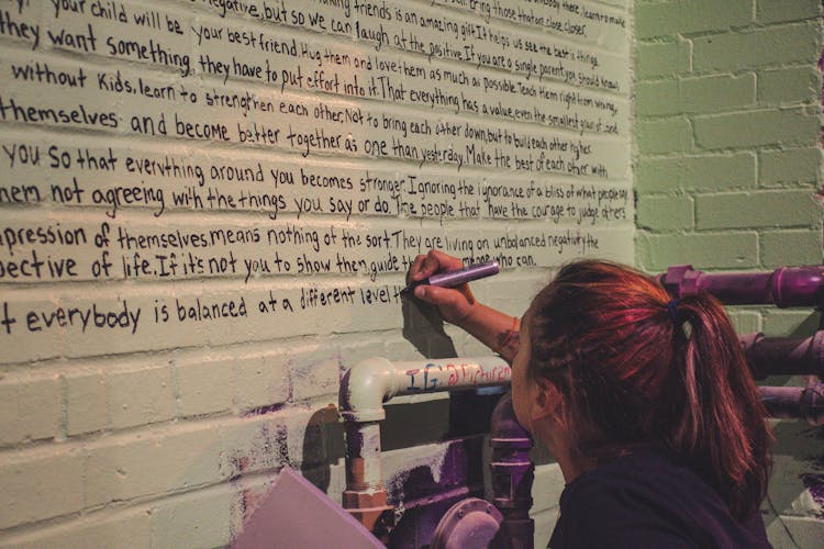 Woman Holding Marker Writing On Wall