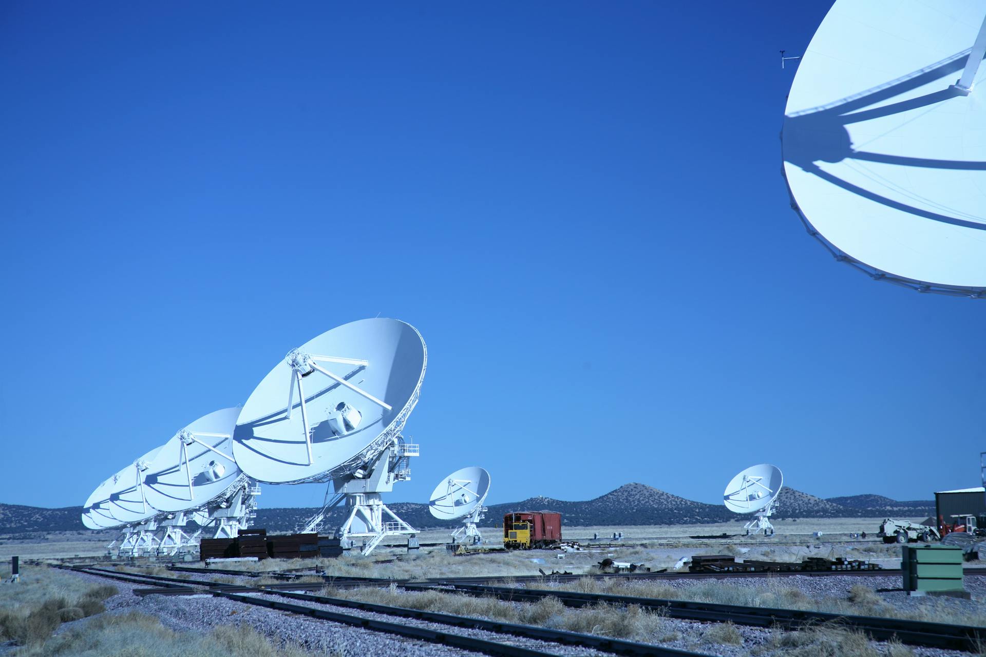 White Satellite Dishes Under the Blue Sky