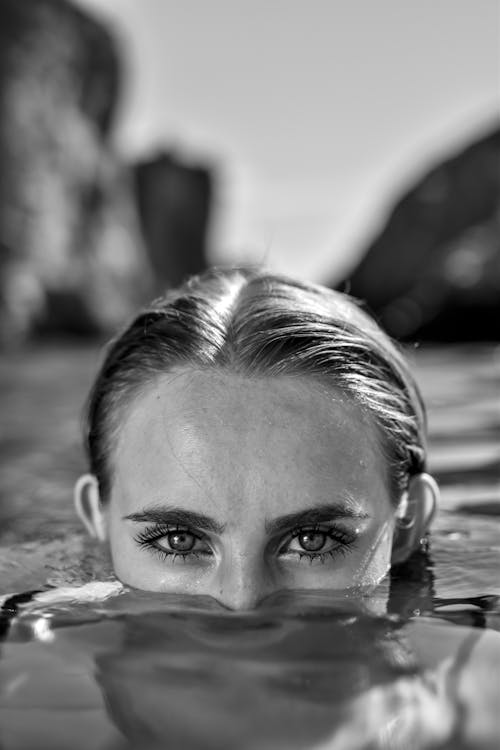 Half Face of a Girl Deep in Water Grayscale Photo
