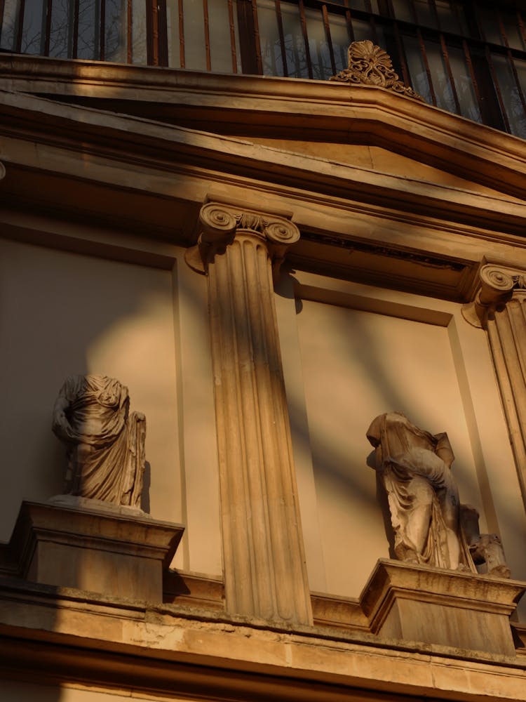 Broken Statues Outside The Wall Of A Building