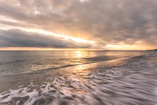 Capture the serene waves and stunning sunset at Fano, Italy's picturesque seaside.
