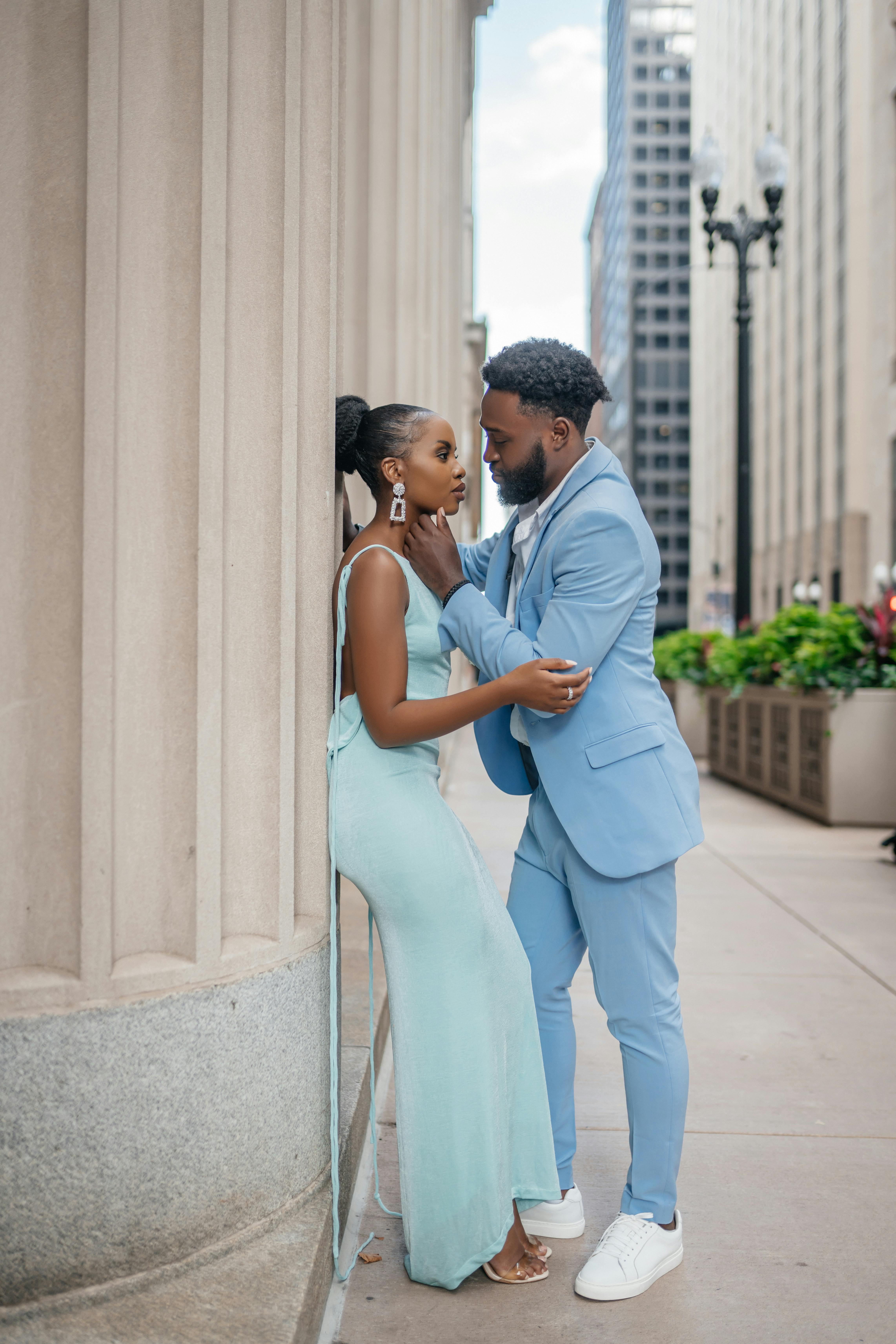 Couple Hugging near Bedrocks on City Street · Free Stock Photo
