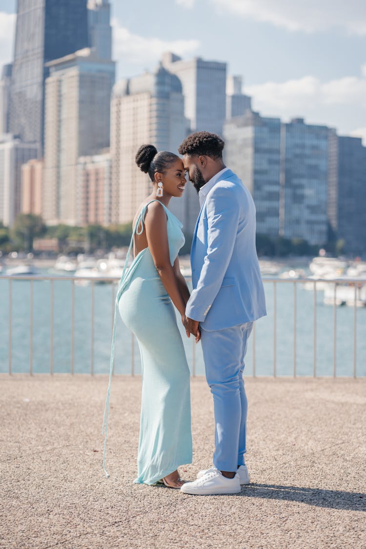 Couple Holding Hands On City Background