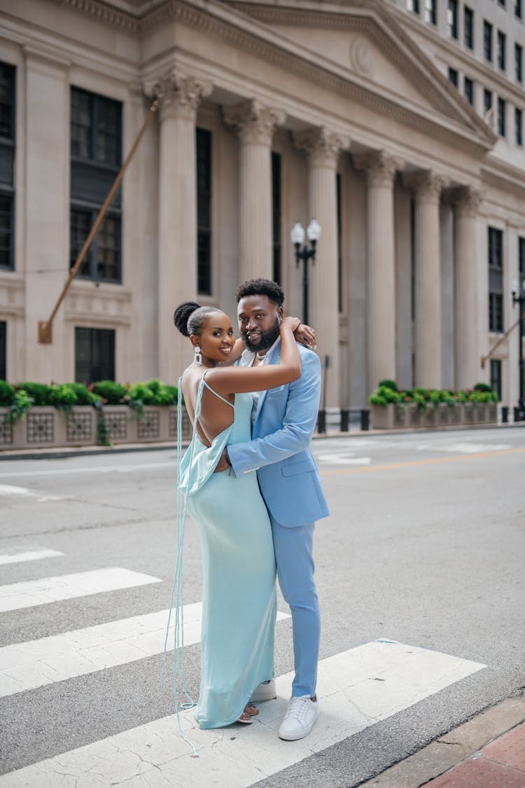 Couple Hugging On Crosswalk Near Old Building 