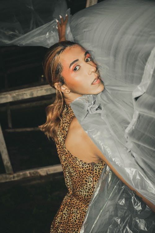Woman in a Cheetah Print Dress Holding Plastic Foil 