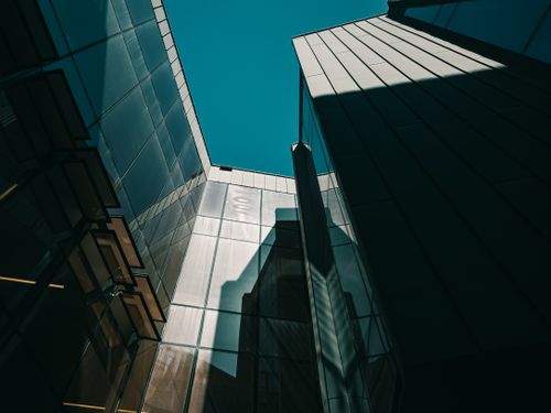 Free Low-angle shot of modern skyscrapers with glass panels reflecting light under a clear sky. Stock Photo