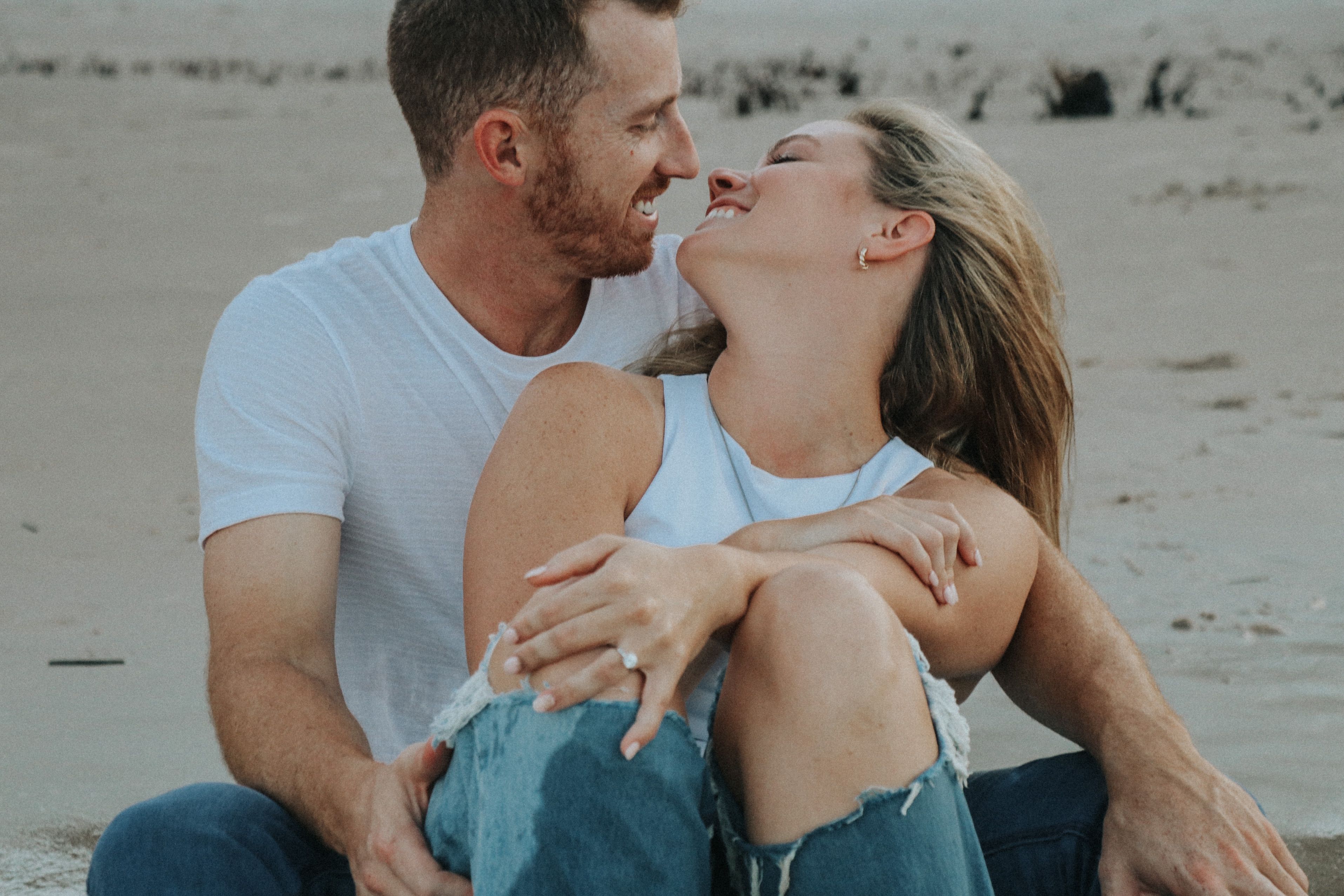 A Man in White Crew Neck T-shirt Kissing Woman in Blue Denim Jeans on ...
