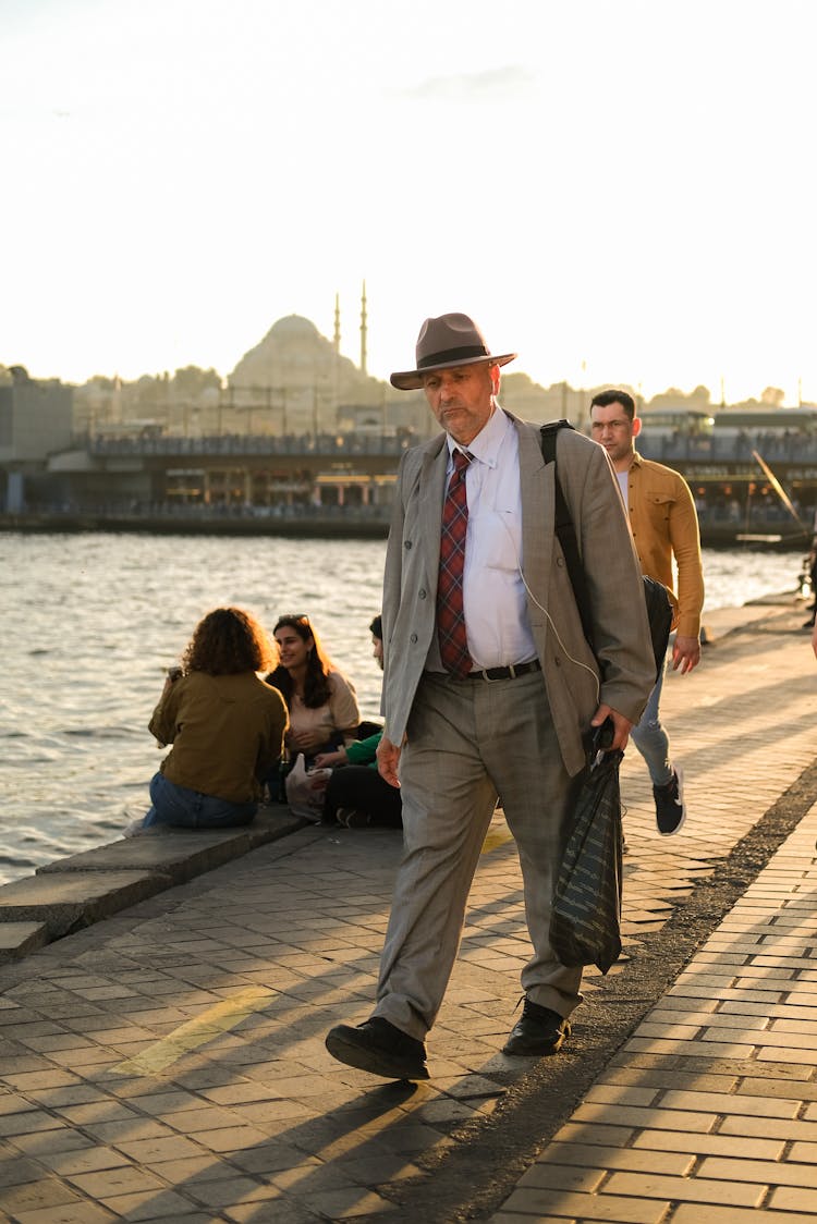 An Elderly Man Wearing A Suit And Hat