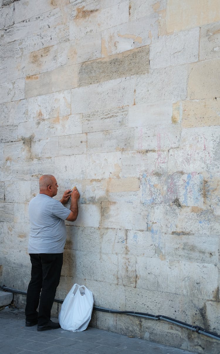 A Man Facing The Wall