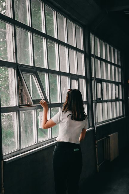 person opening window for ventilation