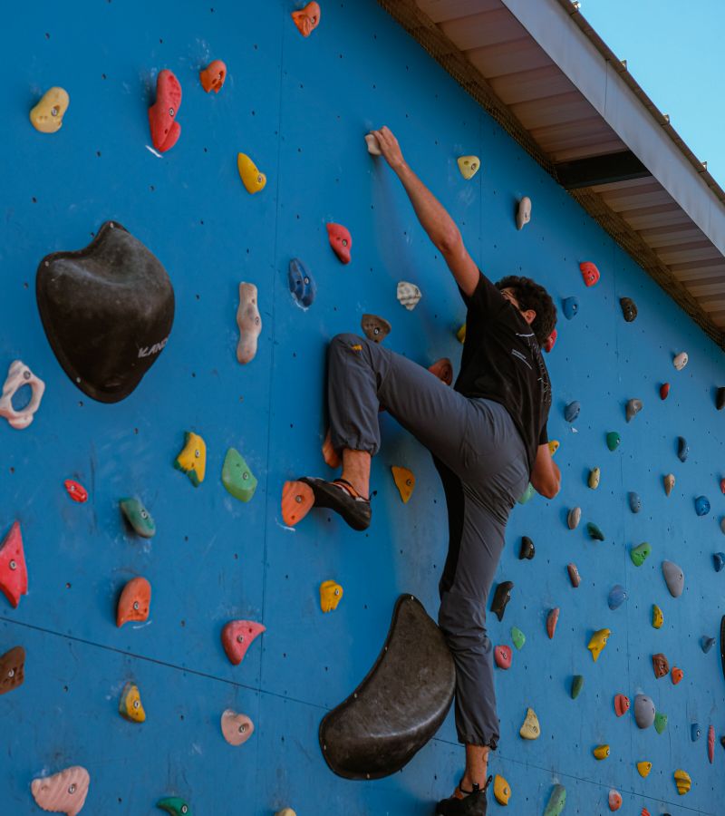A climber working a bouldering problem