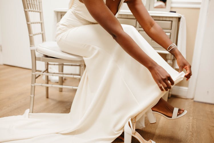 Bride In Wedding Dress Sitting On Chair