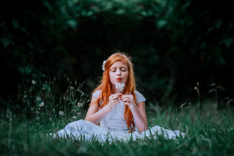 Girl Blowing Dandelions