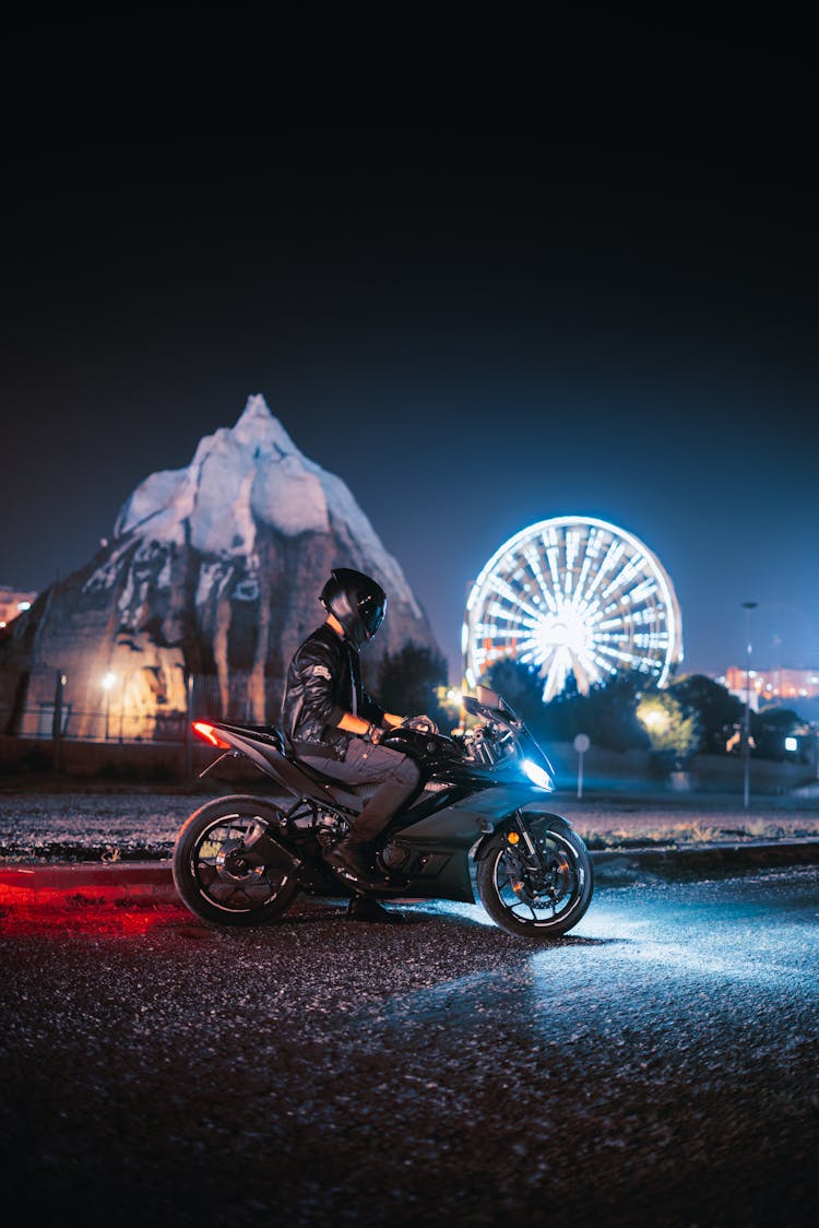 A Person On A Motorcycle At Night