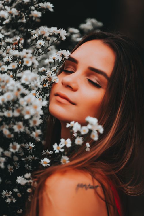Beautiful Young Woman Standing with Eyes Closed and a Bunch of Flowers ...