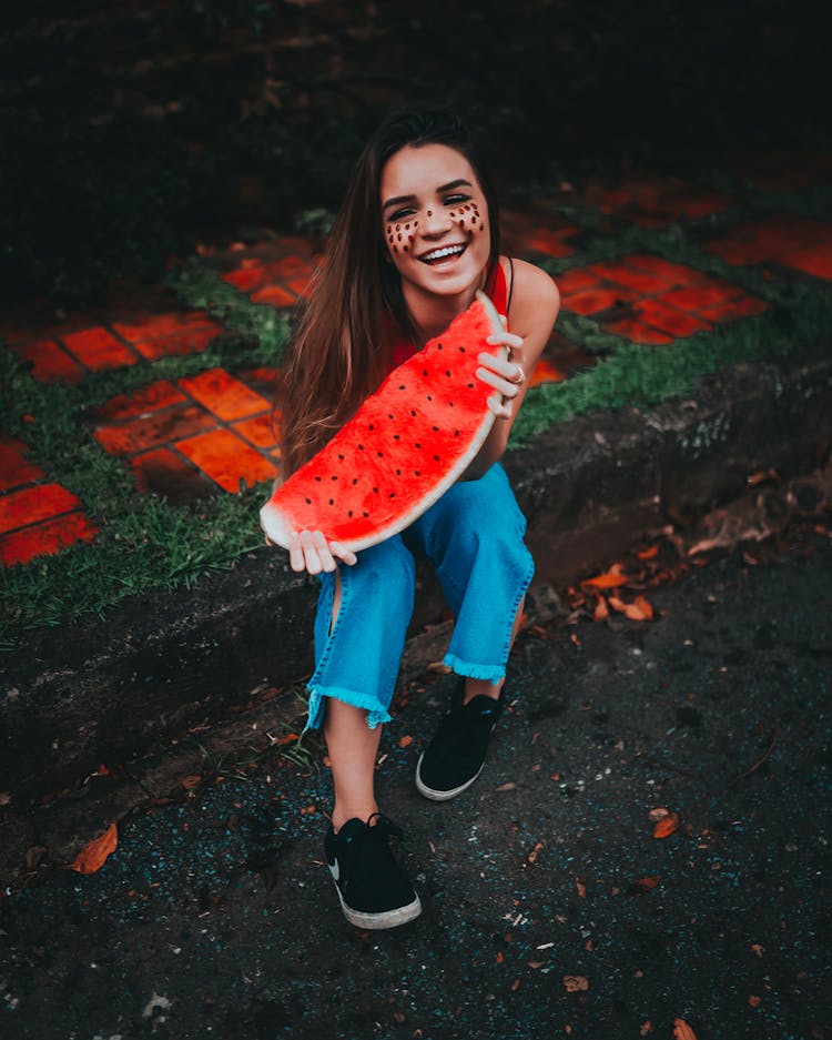 A Woman Holding Watermelon Slice