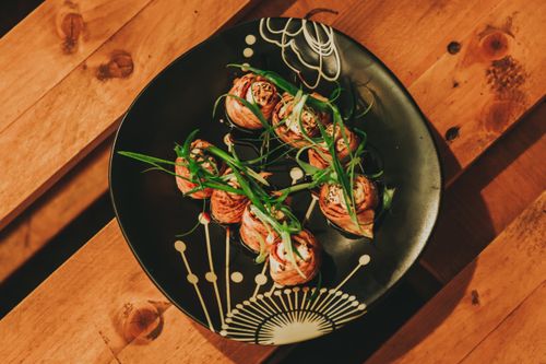 Free Savor the flavors of gourmet sushi rolls elegantly arranged on a decorative plate, perfect for a culinary feast. Stock Photo