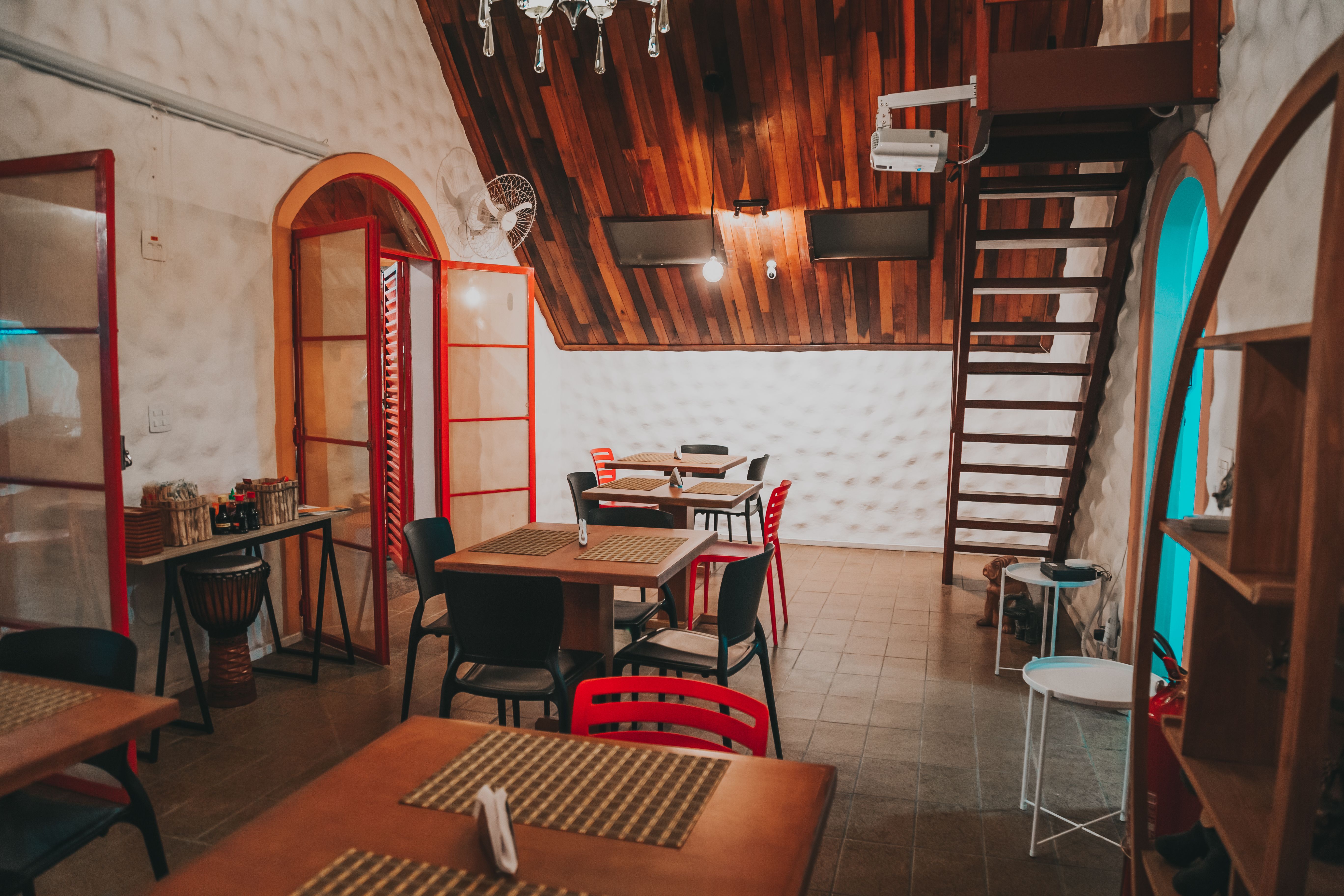 Inviting restaurant space featuring wooden ceiling and eclectic seating arrangements.