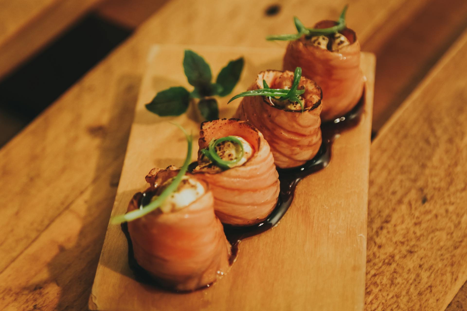 Two Brown and White Sushi on Brown Wooden Chopping Board