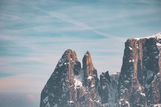 Stunning view of the snow-covered rocky peaks in the Dolomites under a clear sky.