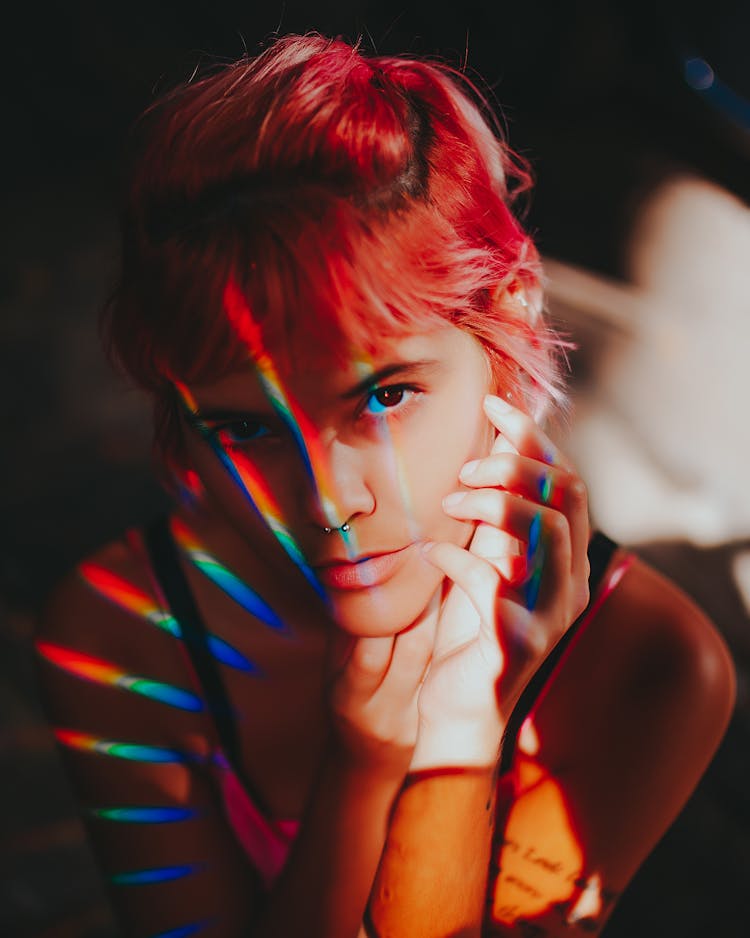 Rainbow Light On Womans With Pink Hair Face 
