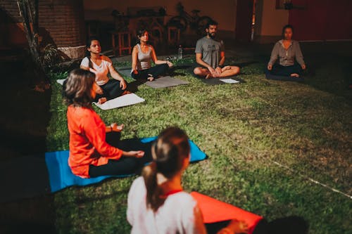 Free People Sitting on Yoga Mats Stock Photo