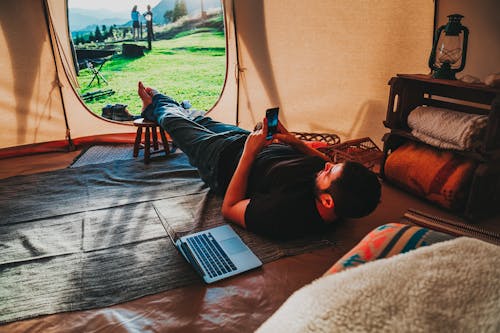 Man in Black T-shirt Lying inside the Tent