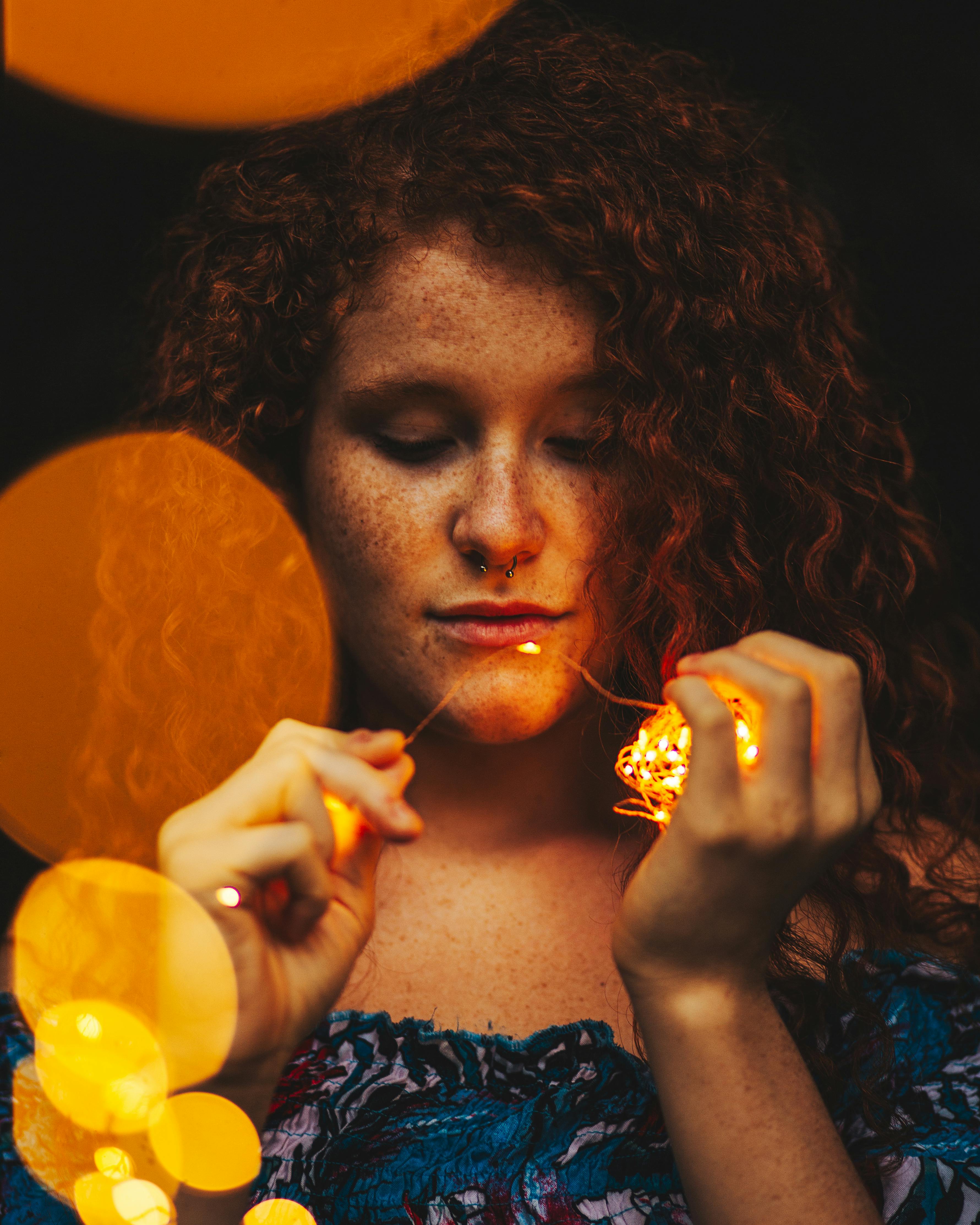 Woman Holding Lighted Yellow String Lights · Free Stock Photo
