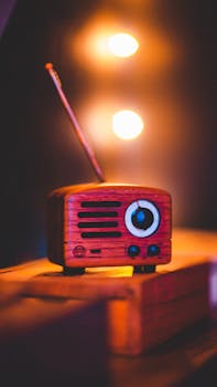 Close-up of a retro wooden radio against warm ambient lights, showcasing a vintage style.