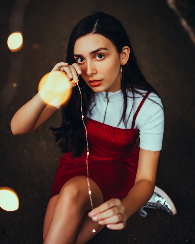 Young Brunette Woman Holding A String Of Fairy Lights