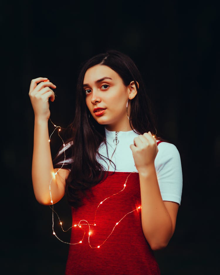 Young Brunette Woman Holding A String Of Fairy Lights