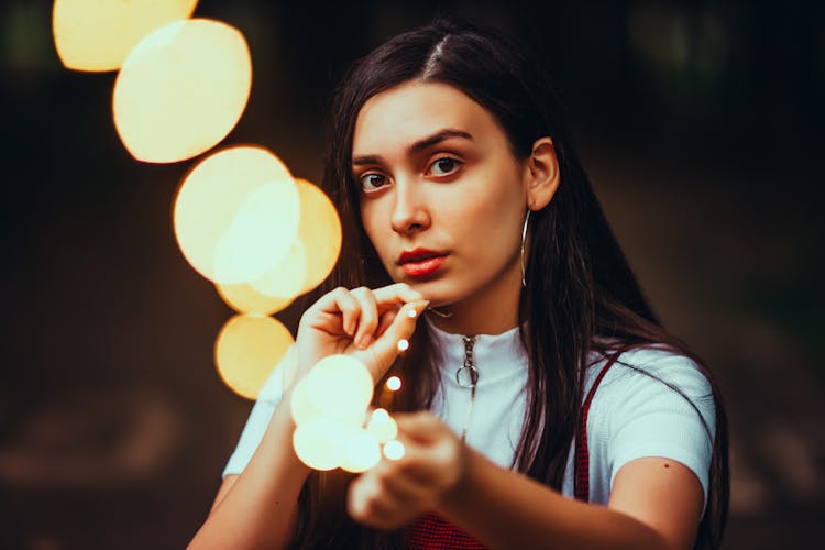 Young Brunette Woman Holding A String Of Fairy Lights