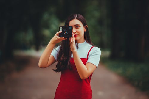 Free A Woman Taking a Picture With an Instant Camera  Stock Photo