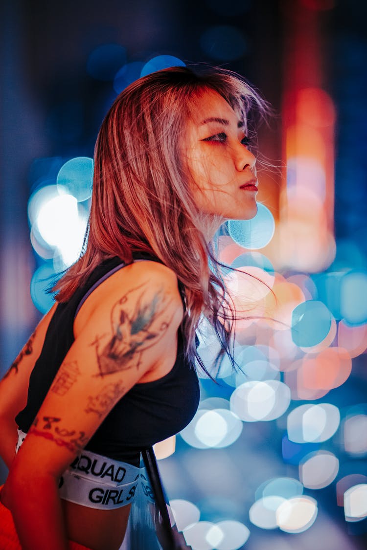 Girl Looking Out Of Balcony In Night With Lights