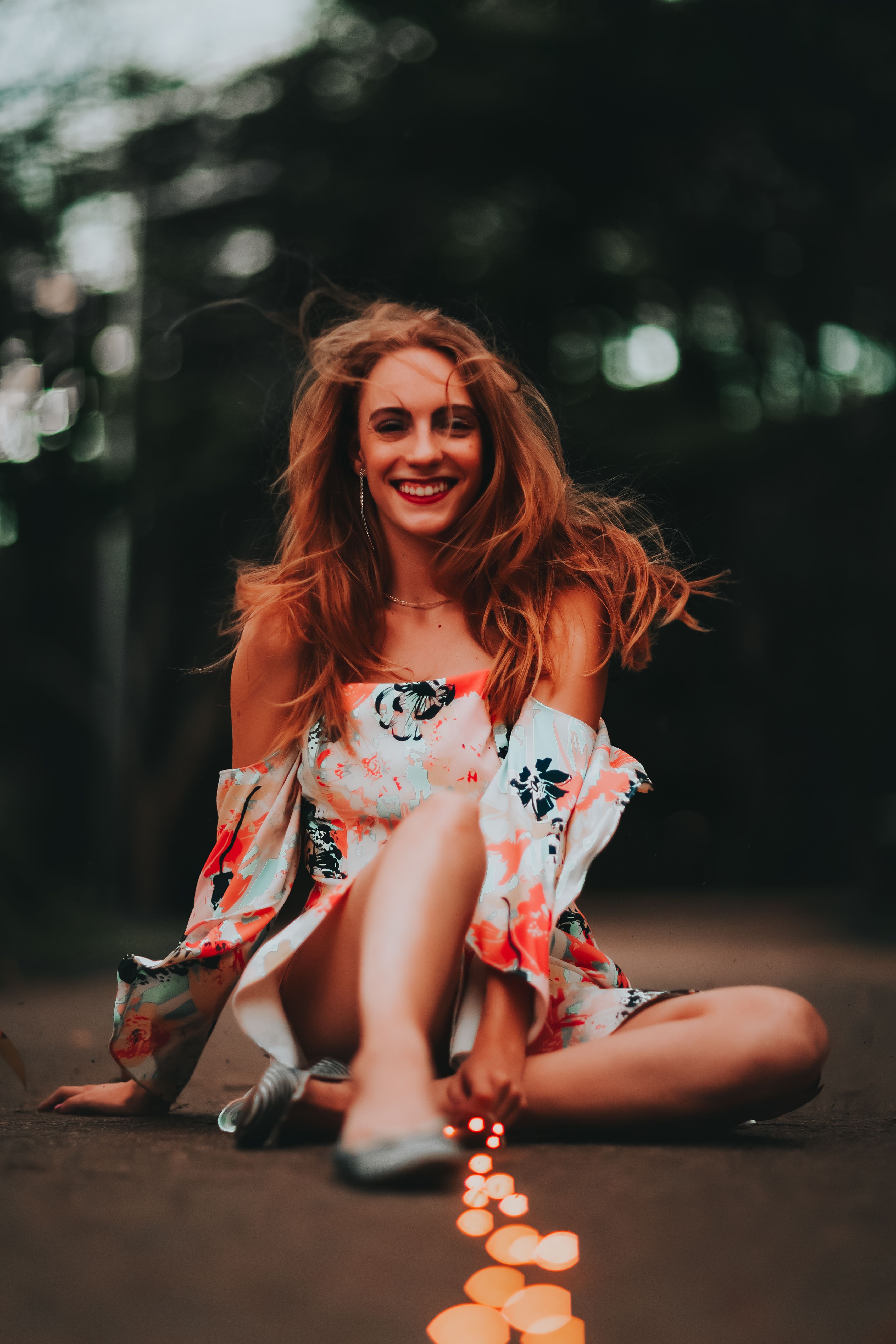 Smiling Woman Sitting on the Ground · Free Stock Photo