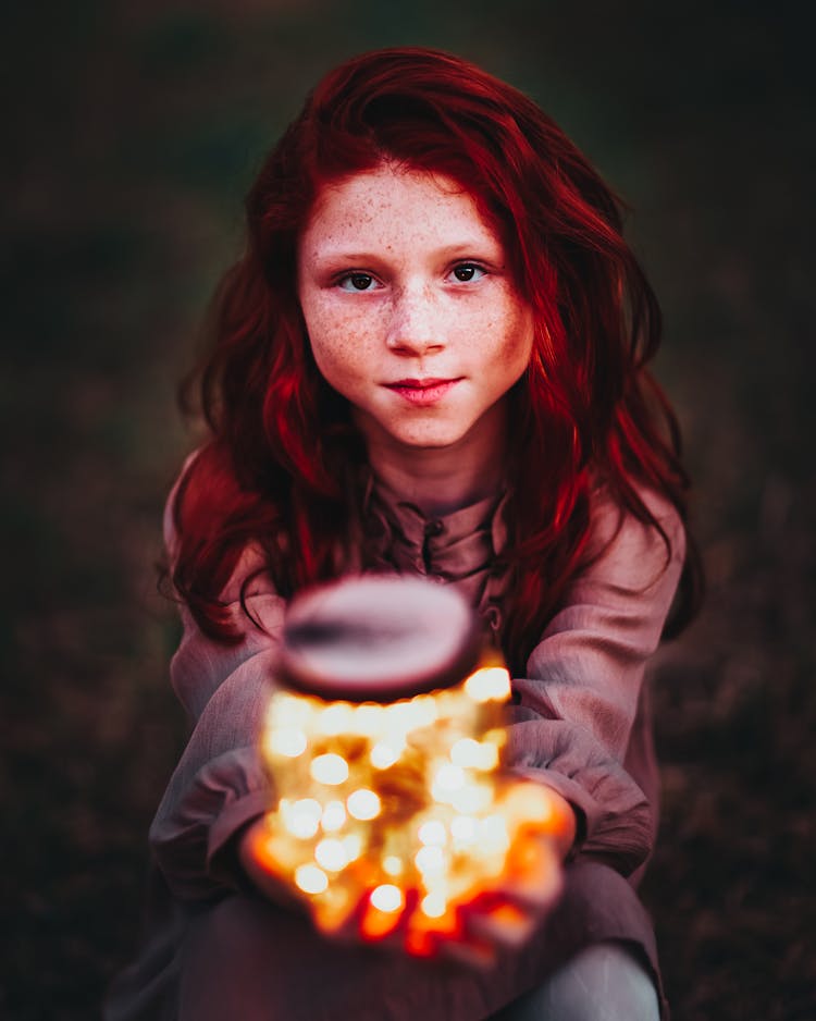 Redhead Girl Holding Jar Full Of Lit Up Fairly Lights