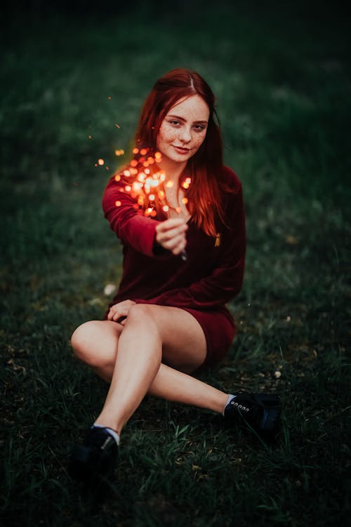 Woman Sitting with Sparkler