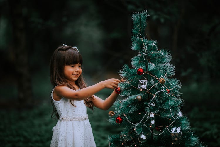 Girl Decorating Christmas Tree