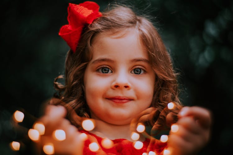 Face Of Girl Holding Lights