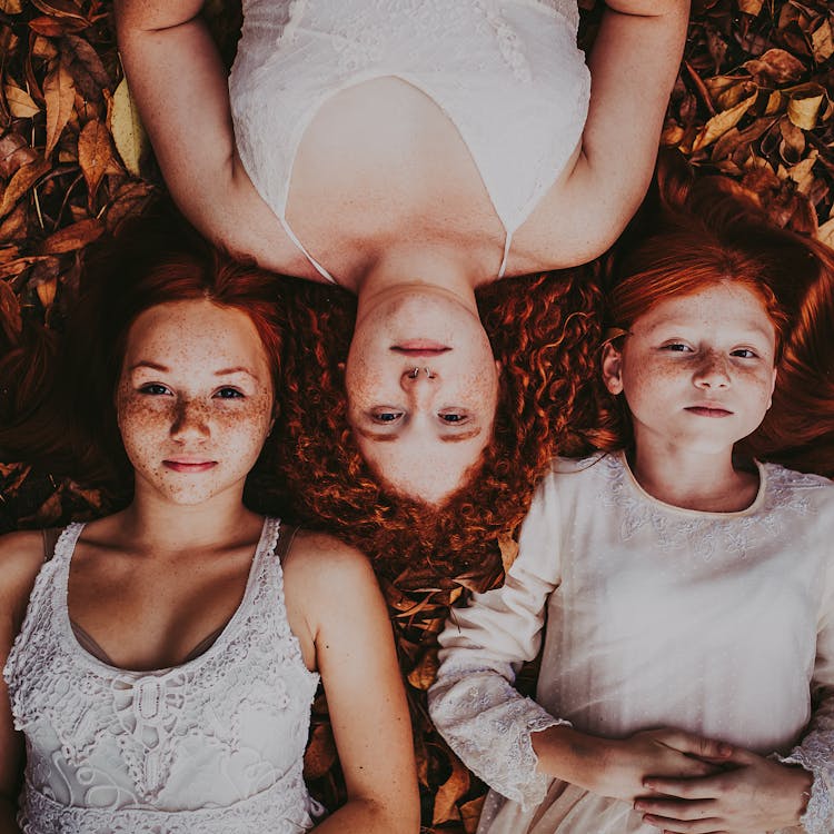 Redhead Girls Lying On Autumn Ground