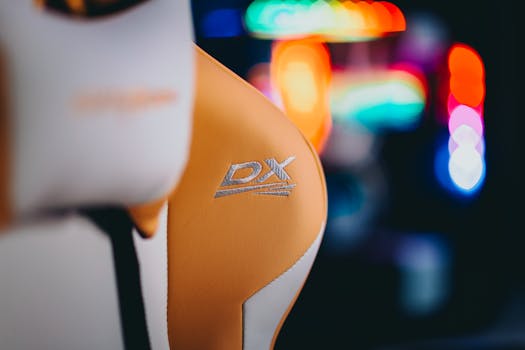 Close-up of a luxurious gaming chair with vibrant LED lighting in the background, ideal for gamers.