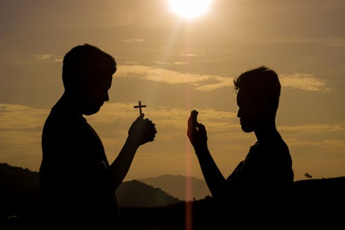 Silhouette of Praying Men