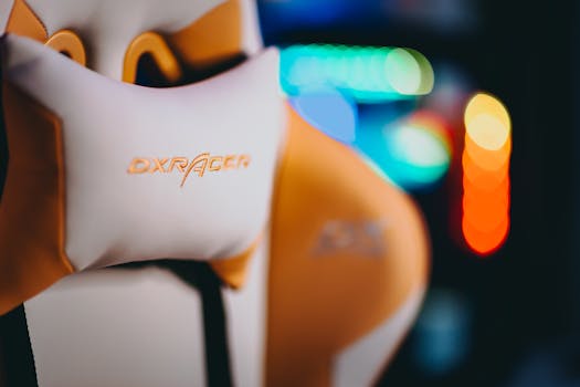 Close-up of a DXRacer gaming chair with colorful bokeh lights in the background.