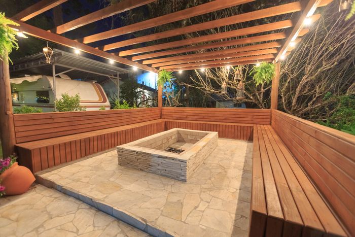 Cedar deck with pergola and built-in bench seating in a suburban backyard