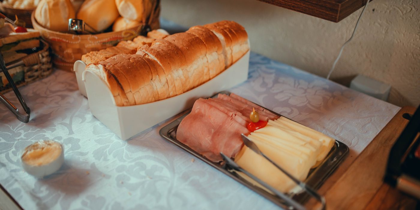 A continental hotel breakfast setup with pastries, fruit and coffee