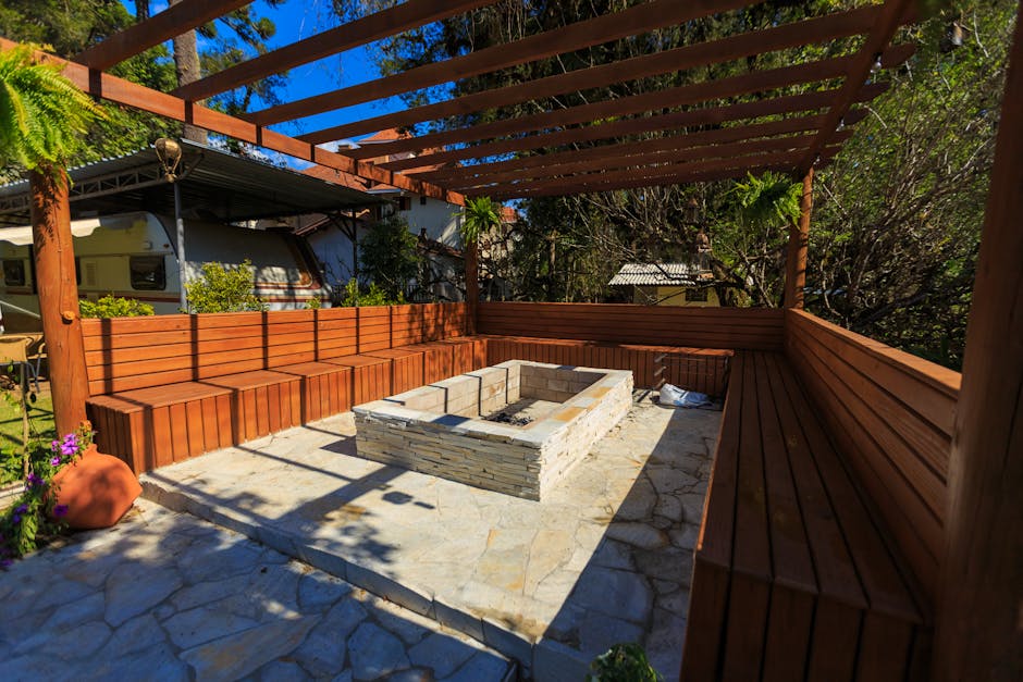 A beautiful outdoor patio with natural stone and a fire pit - hardscaping contractor