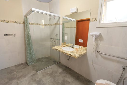 Spacious and accessible bathroom featuring a large glass shower, modern sink, and stylish decor.