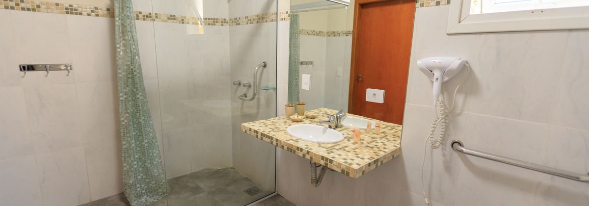 A bathroom with a walk-in shower and grab bars