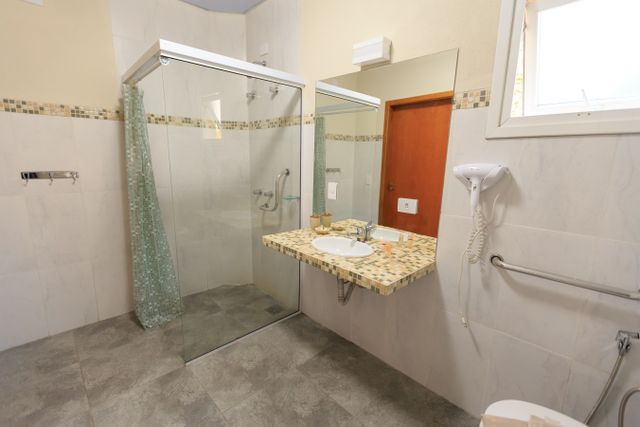 Accessible bathroom with walk-in shower and support rails