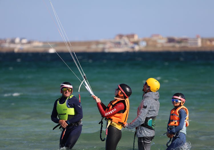 People Holding Lines In Water